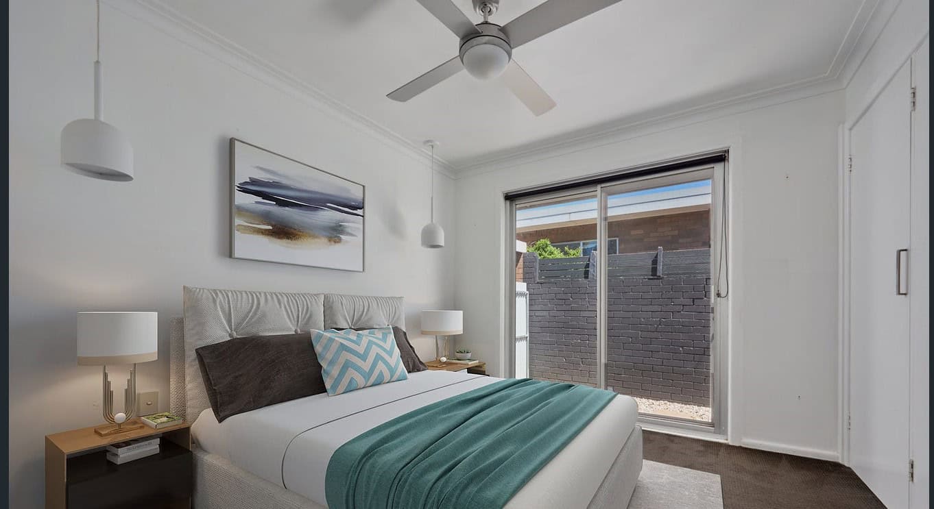Bright modern bedroom with large sliding glass door, stylish decor, and ceiling fan; ideal for property investment or homebuyers seeking Brisbane property sales from Ember Estate Agents.